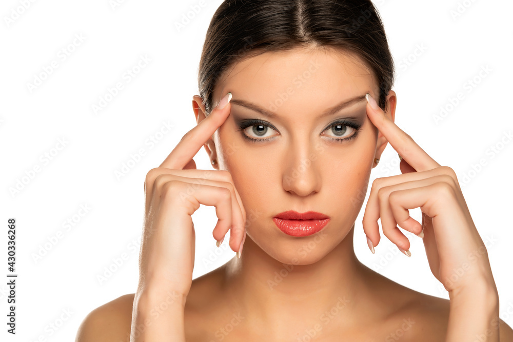 Young woman tightening her face skin with her fingers