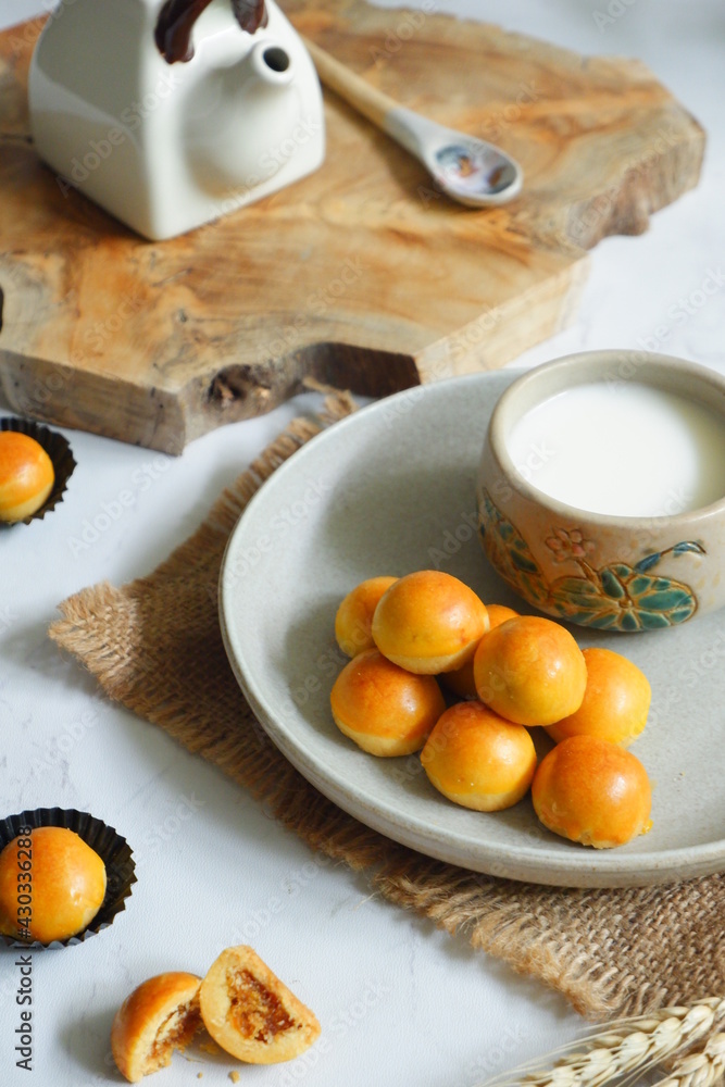 a plate of pineapple tart served with fresh milk on the table a plate of pineapple tart served with fresh milk on the table