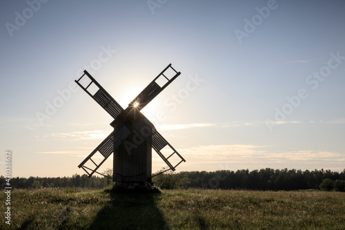 Scenic silhouette view to the traditional wooded windmill in the sunset light