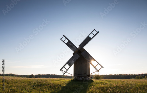 Scenic silhouette view to the traditional  wooded windmill in the sunset light