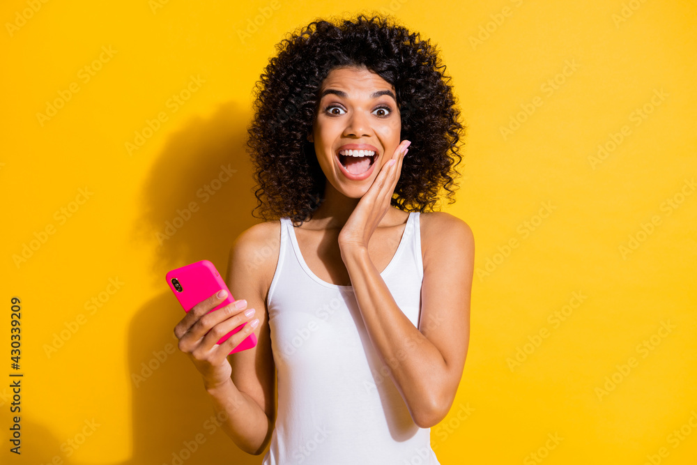 Photo of astonished dark skin person arm on cheek open mouth news follow isolated on yellow color background Photo of astonished dark skin person arm on cheek open mouth news follow isolated on yellow color background
