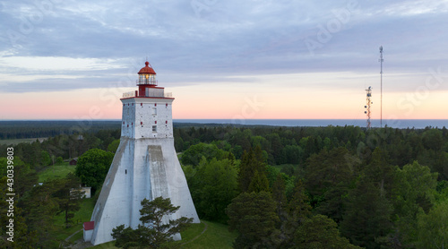 Scenic aerial view to the historic Kõpu lighthouse in Hiiumaa isl, Estonia on the background the sunrise colored sky and sea photo