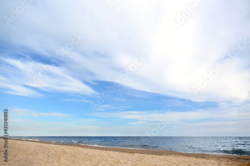 Beautiful sea coast with seagulls under blue sky