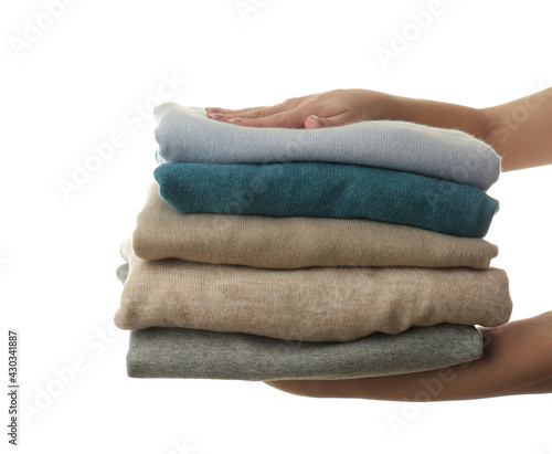 Woman with folded cashmere clothes on white background, closeup