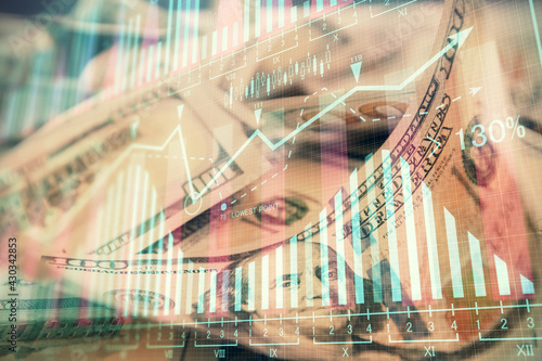 Double exposure of forex graph drawing over us dollars bill background. Concept of financial markets.