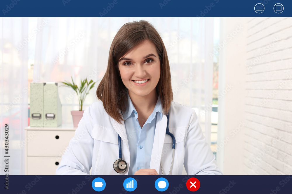 Obraz na plátně Pediatrician consulting patient online using video chat in clinic, view from web