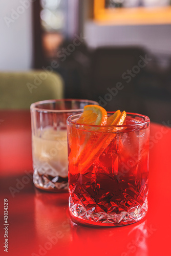 Cocktails with fruits and berries in a bar or restaurant. Blurred background. Alcoholic beverages.