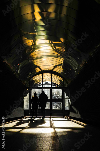 Stockholm, Sweden Pedestrians walking into the sunshine in the Brunkebergs tunnel in downtown. photo