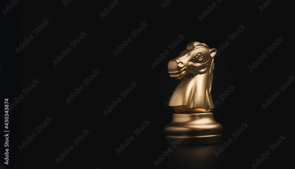 Golden knight horse chess on black background, business strategy concept. Golden knight horse chess on black background, business strategy concept.