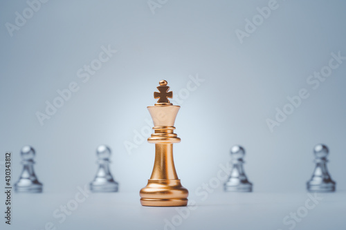 Golden of king chess in front of silver pawns chess for leadership concept.