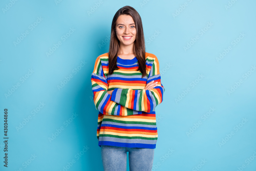 Photo of young attractive woman happy positive smile confident crossed hands isolated over blue color background Photo of young attractive woman happy positive smile confident crossed hands isolated over blue color background