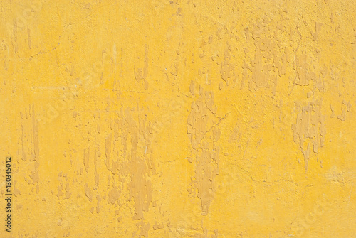 Plaster on a yellow wall. Concrete wall texture close up.