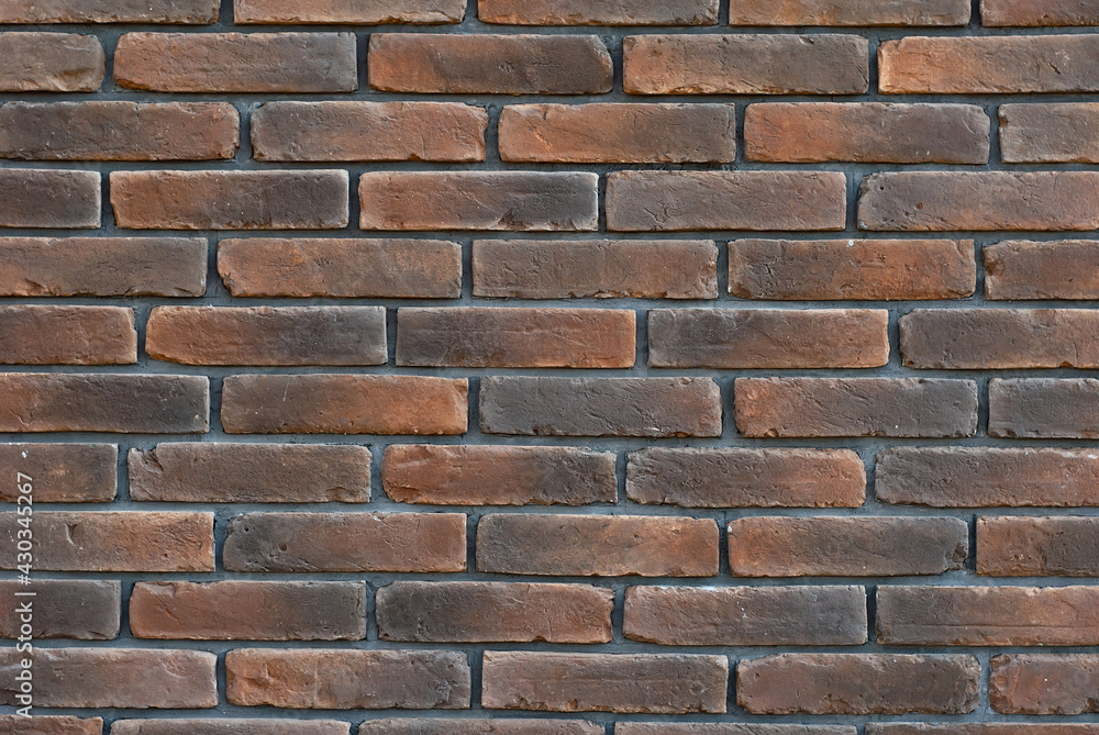 Texture of brick wall. Samples of wall or fence are presented at exhibitions. Purple brick close up. Texture of brick wall. Samples of wall or fence are presented at exhibitions. Purple brick close up.
