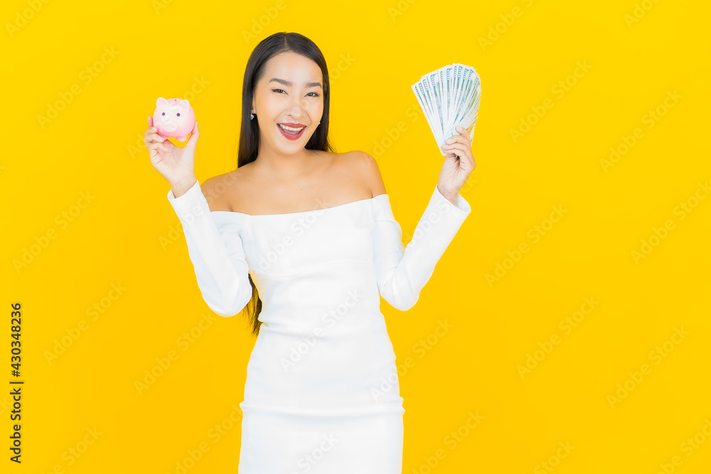 Portrait beautiful young business asian woman with a lot of cash money and piggy bank Portrait beautiful young business asian woman with a lot of cash money and piggy bank