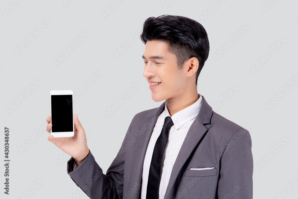 Portrait young asian business man showing and presenting smartphone with blank with success isolated on white background, businessman standing and holding phone, communication concept. Portrait young asian business man showing and presenting smartphone with blank with success isolated on white background, businessman standing and holding phone, communication concept.