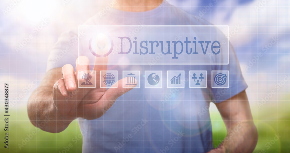 A man in a t-shirt outside selecting a Disruptive word concept on a computerised display