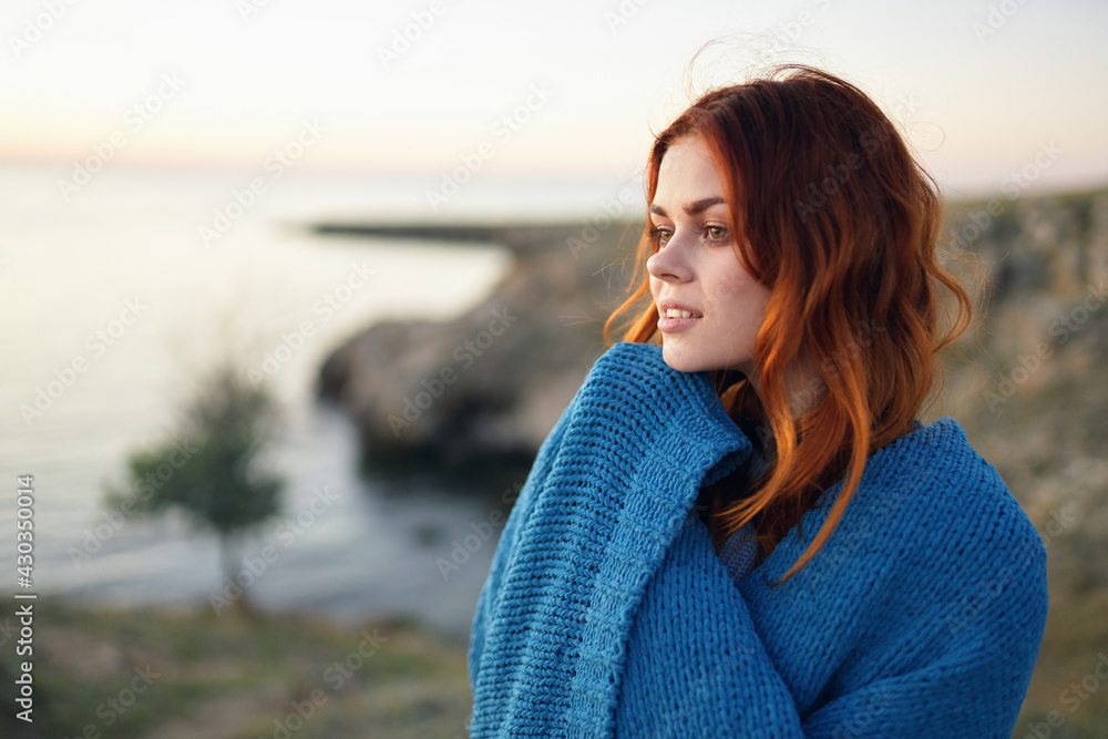 red-haired woman in a blue plaid in the mountains nature fresh air