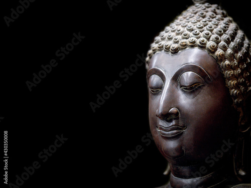 Buddha face statue. A heritage antique symbol of clam, enlighten and meditate. Head and face statue of Buddhism religion, show traditional culture of Asian spirituality. Portrait sculpture style.