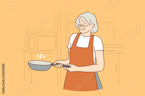Happy elderly cooking lifestyle concept. Smiling mature aged woman in apron cartoon character standing holding cooking pan vector illustration 