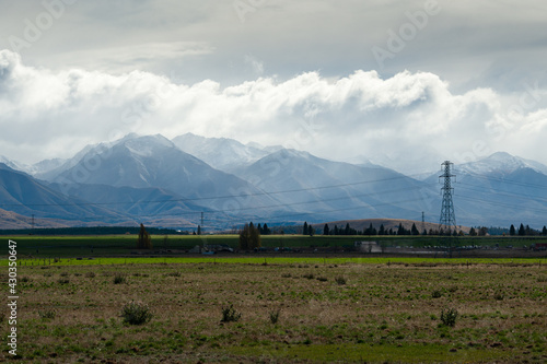 High voltage transmission towers and power lines with Ben Ohau Range in the background, Twizel, South Island photo