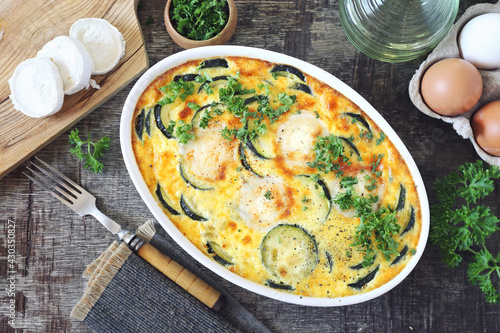 French cuisine. Vegetable zucchini clafoutis with goat cheese in ceramic bakeware