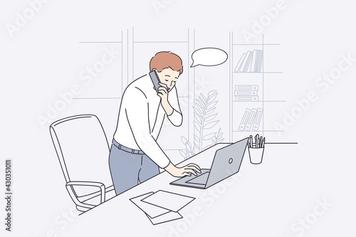 Working in office, communication concept. Young businessman office worker cartoon character standing talking on phone while typing on laptop vector illustration 