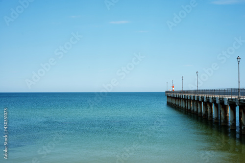 Calm blue sea and pier © ottochka