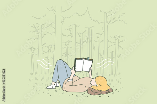 Relaxation, leisure and reading concept. Young happy woman cartoon character lying on grass in park reading book feeling relaxed vector illustration 