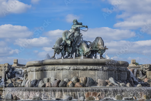 View of famous Gefion Fountain (Gefionspringvandet, 1899) in Copenhagen. Gefion Fountain depicting legendary Norse goddess driving four oxen. It designed by Danish artist Anders Bundgaard. Denmark.
