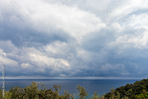 italian landscape with hill view mediterranean sea, nature, houses and clouds on sea in cloudy day