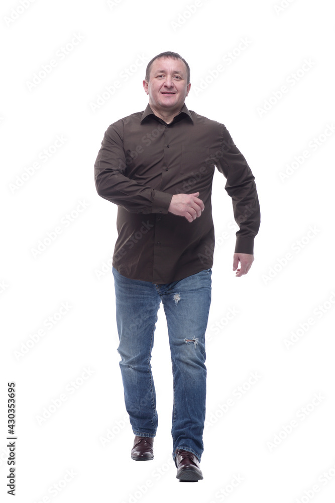 in full growth. satisfied casual man striding forward . in full growth. satisfied casual man striding forward .