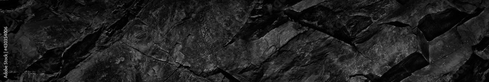Black white rock texture. Dark stone background with copy space for design. Web banner. Website header. Black white rock texture. Dark stone background with copy space for design. Web banner. Website header.