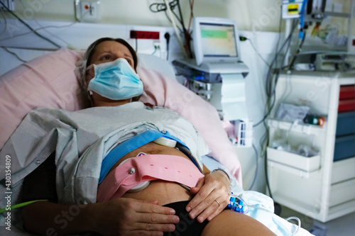 Pregnant woman in labor at hospital with monitors