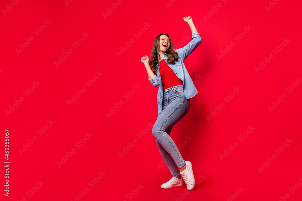 Full length body size photo of woman dancing at party relaxing isolated on vibrant red color background with copyspace