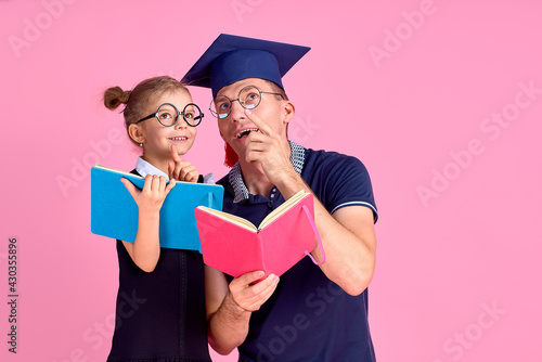Man in academic hat holding book, study together with cute prete photo