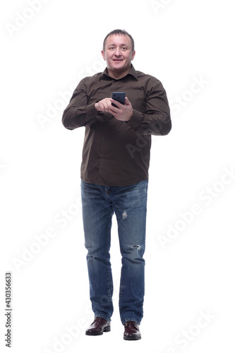 in full growth. smiling mature man with a smartphone.