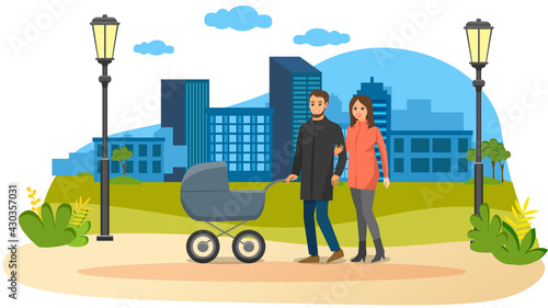 Young parents strolling in park with gray baby stroller. Dad rolls stroller with newborn, wife holds arm of husband. Family walking in park. Mom and dad on background of city with modern buildings