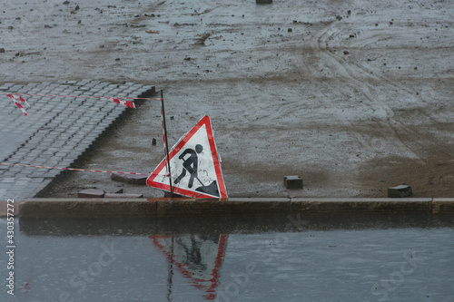 Sign Repair work in rainy weather. Sign 