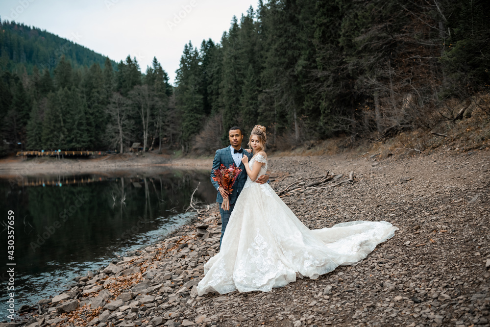 Bride and groom at wedding ceremony on the beautiful lake background. Bride and groom at wedding ceremony on the beautiful lake background.