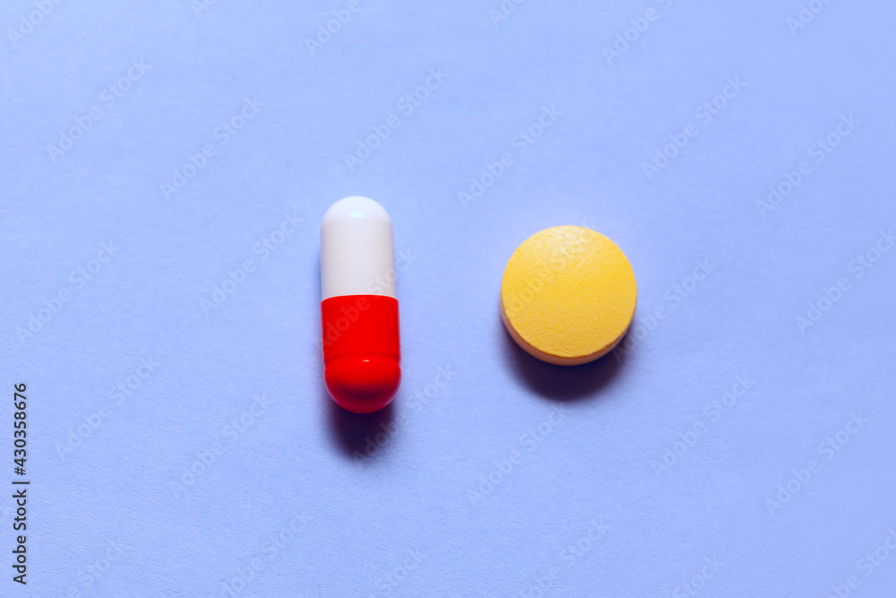 Probiotics and antibiotic pills . Treatment of Helicobacter Pylori . Drugs at blue background Probiotics and antibiotic pills . Treatment of Helicobacter Pylori . Drugs at blue background
