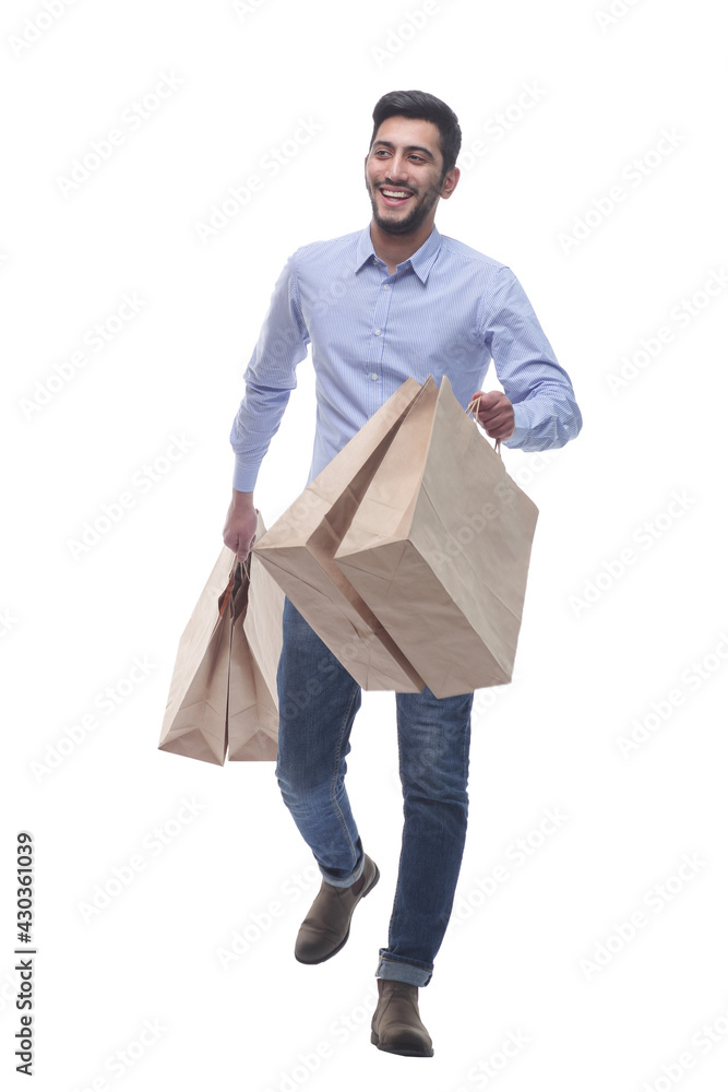 young man with shopping bags striding forward. young man with shopping bags striding forward.