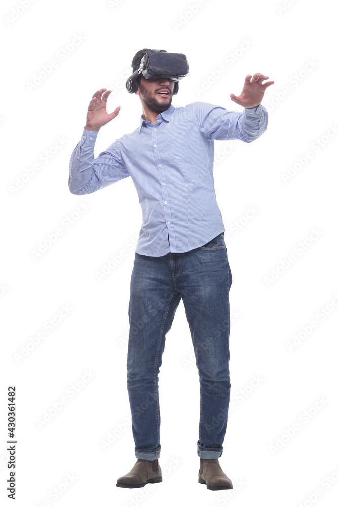 in full growth. smiling young man wearing virtual reality glasses. in full growth. smiling young man wearing virtual reality glasses.