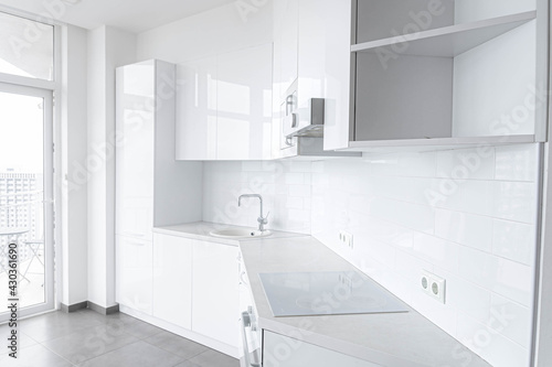 white modern kitchen with built-in appliances
