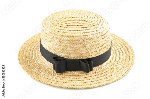 Pretty straw hat with black ribbon isolated on white background.