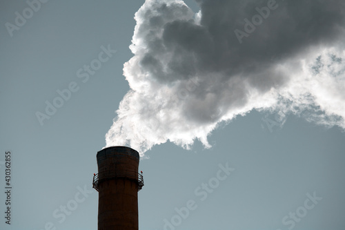 Production Pipe with White Smoke against A Gray Sky. Emissions to the Atmosphere. Concept Air and Environmental Pollution