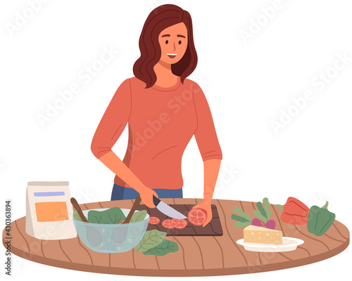 Woman preparing salad using vegetarian ingredients in kitchen. Proper nutrition, healthy lifestyle and vegetarianism concept. Process of cooking vegetarian food. Girl cuts vegetables for healthy dish