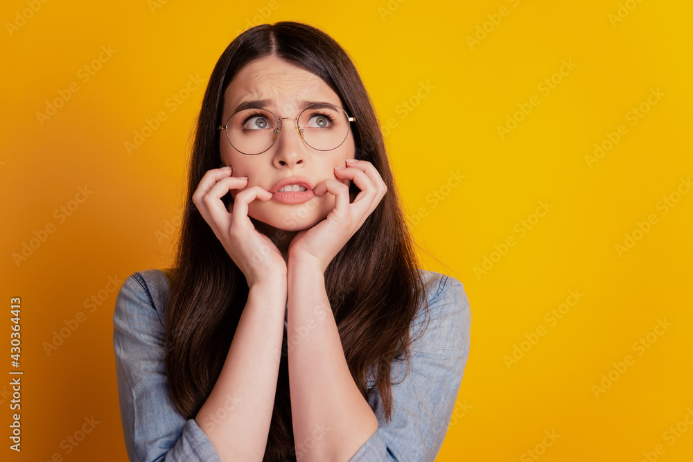 Photo of afraid girlfriend driven mad look up empty space isolated yellow color background Photo of afraid girlfriend driven mad look up empty space isolated yellow color background