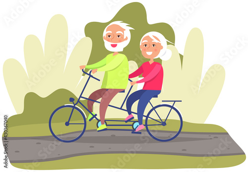 Elderly couple riding twin or tandem bicycle on road in park or lawn. Old woman and man are spending time actively. People in relationship together in nature. Grandparents riding double bike