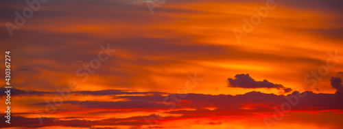 Beautiful orange clouds in the summer sunset sky