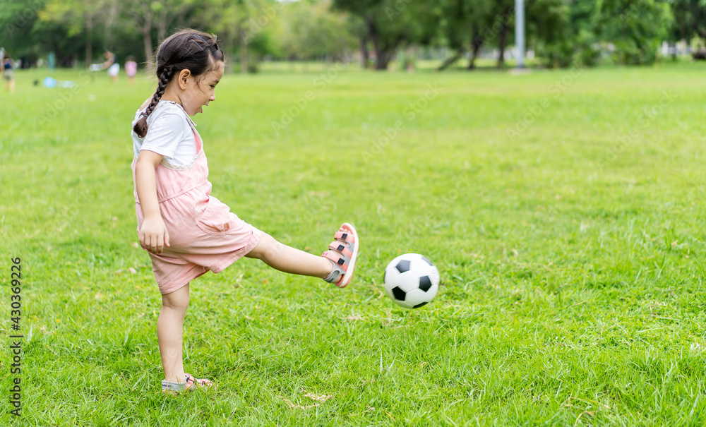 Sports kid. Happy little girl kid kicking a soccer ball, Child plays Sports kid. Happy little girl kid kicking a soccer ball, Child plays